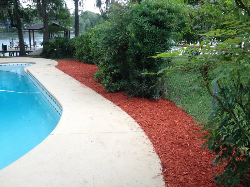 red mulch beside pool deck in Fleming Island, FL