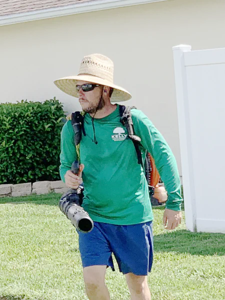 Person wearing a backpack blower while standing in a yard in Middleburg, FL